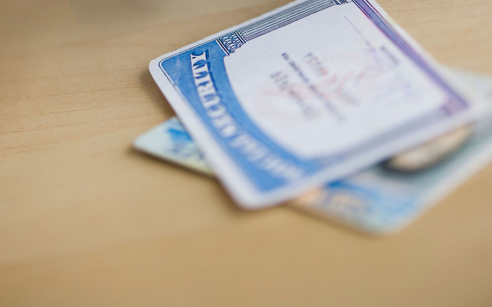 CFM26A Close up of thief's hand in black glove stealing driver's license, studio shot. Image shot 2012. Exact date unknown.