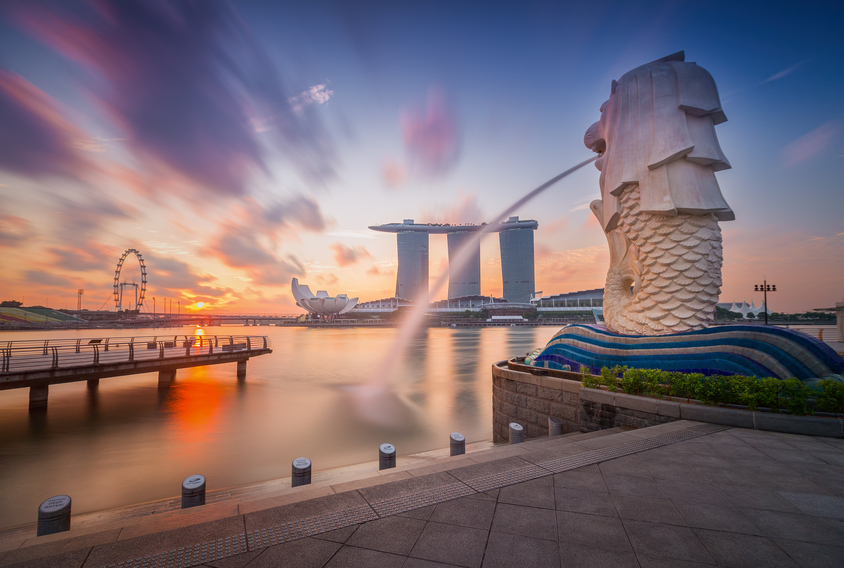 Singapore, Singapore - September 1, 2014:  The Merlion fountain in front of the Marina Bay Sands hotel in Singapore. Merlion is a imaginary creature with the head of a lion,seen as a symbol of Singapore